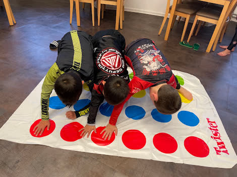 Three kids playing Twister during the evening program