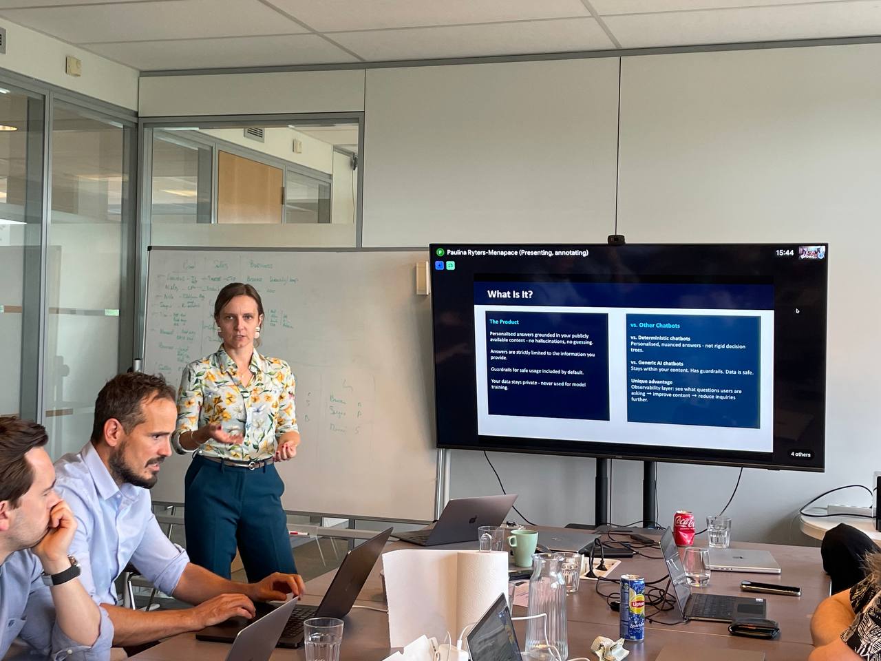 Paulina Ryters-Menapace pitching an AI chatbot case at the Dropsolid AI off-site