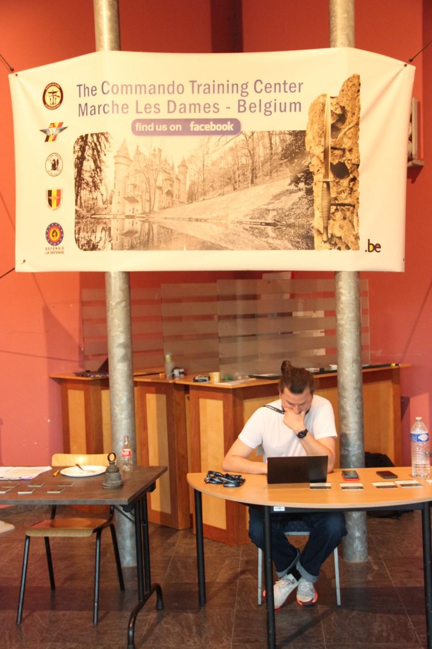 Participant working on a laptop at the Commando Training Center Marche-les-Dames, Belgium, during the Battlefield of Things hackathon