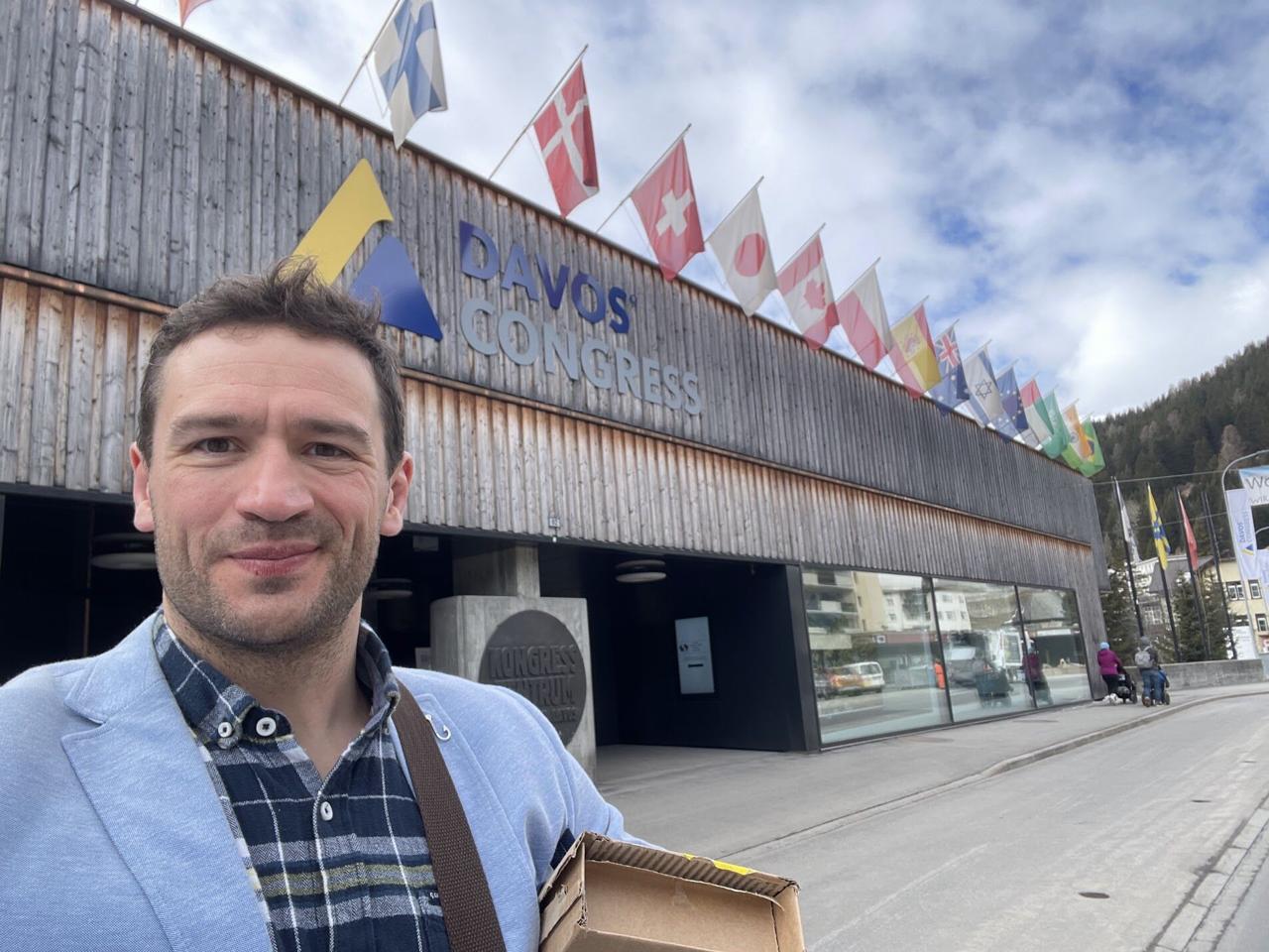 Frederik in front of the Davos Congress building with international flags