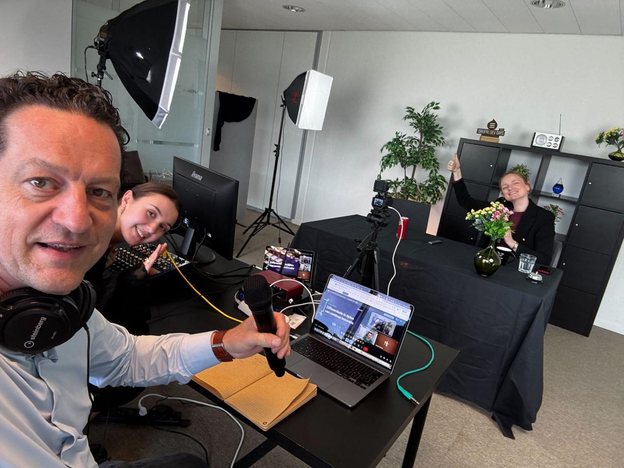 Frederik with headphones and microphone, Carlo and colleague in the background