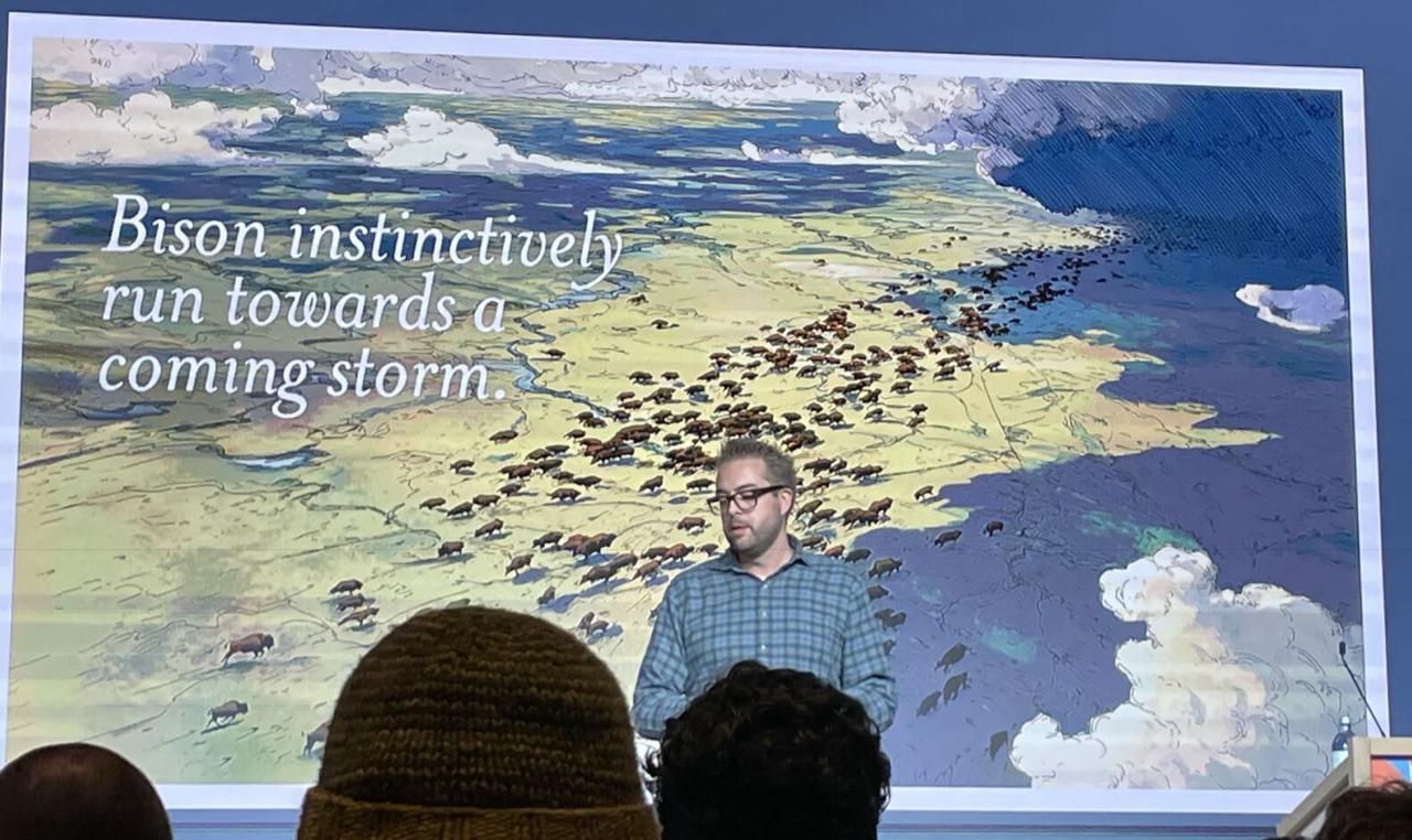 Speaker on stage with slide: Bison instinctively run towards a coming storm