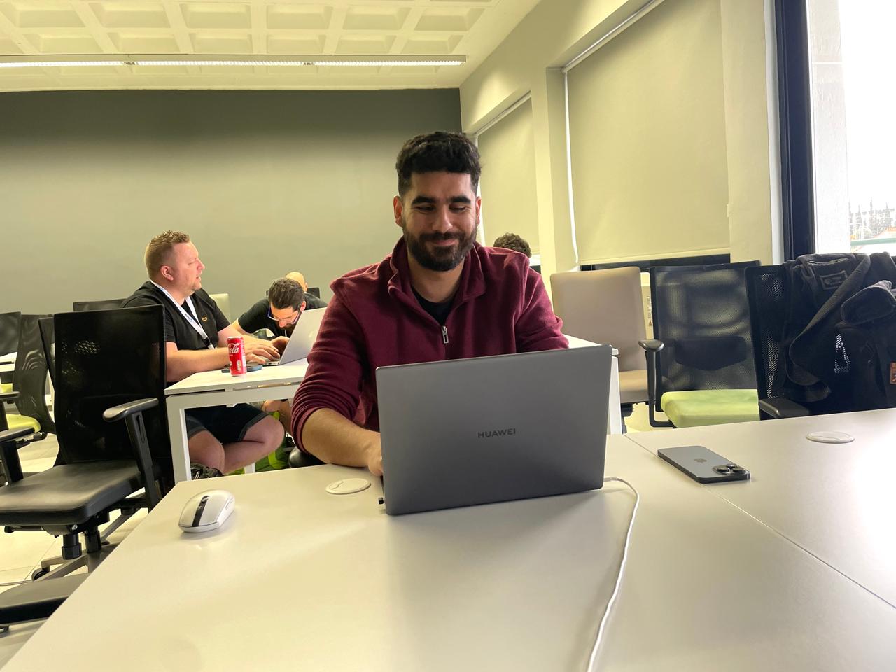 Marios at his laptop coding the DrupalWatch module during the Vibe Coding Challenge