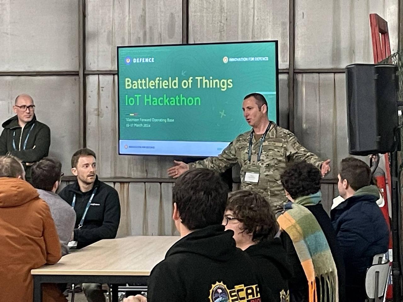 Belgian Army officer briefing participants at the Battlefield of Things IoT Hackathon, Vlasmeer FOB 15-17 March 2024