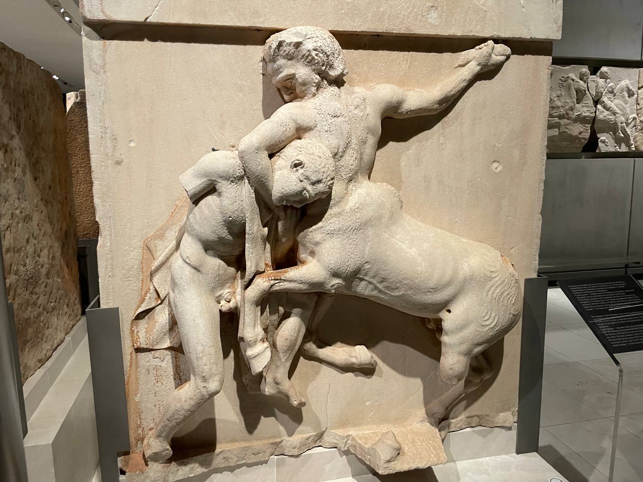 Marble relief from the Parthenon south metopes depicting a Lapith wrestling a centaur into a chokehold, with the centaur's head forced down in a position that resembles a guillotine choke in Brazilian jiu-jitsu