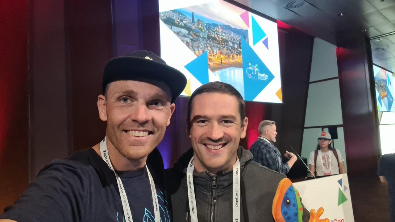 Frederik selfie with James Abrahams at DrupalCon Barcelona in front of the Barcelona night skyline backdrop