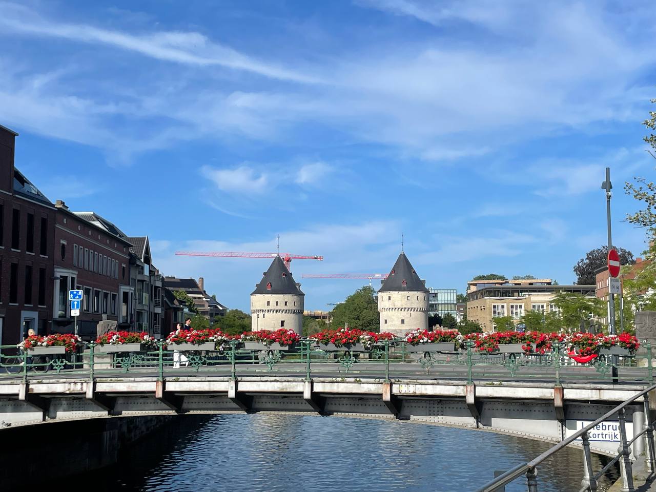 The Broeltorens in Kortrijk, two medieval towers on the Leie river on a summer evening