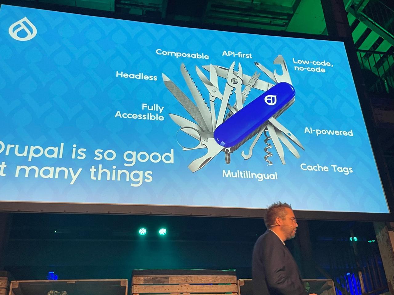 DrupalJam keynote slide: Drupal is so good at many things - Swiss army knife with labels: Headless, Composable, API-first, Low-code no-code, Fully Accessible, AI-powered, Cache Tags, Multilingual