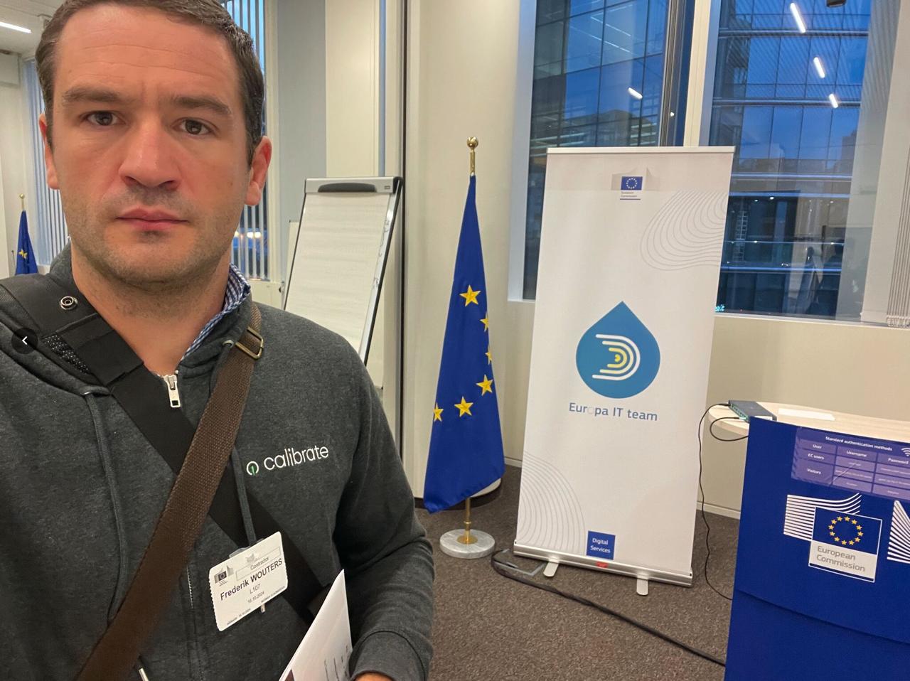 Frederik with Calibrate badge arriving at the European Commission for the hackathon, Europa IT team banner in background