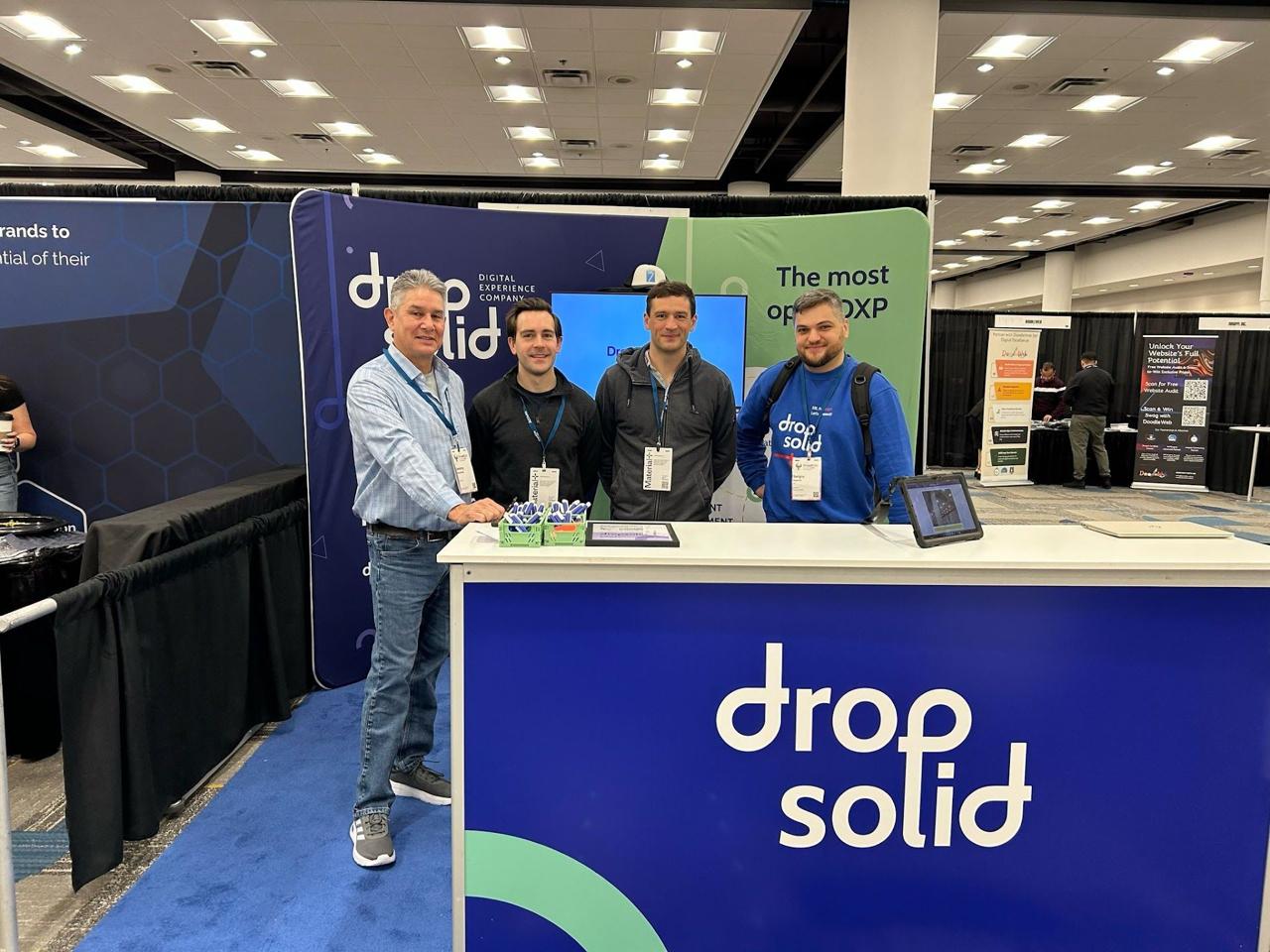 The Dropsolid booth at DrupalCon Atlanta 2025 with four team members